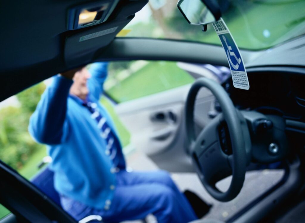 A man sitting in the driver 's seat of his car.