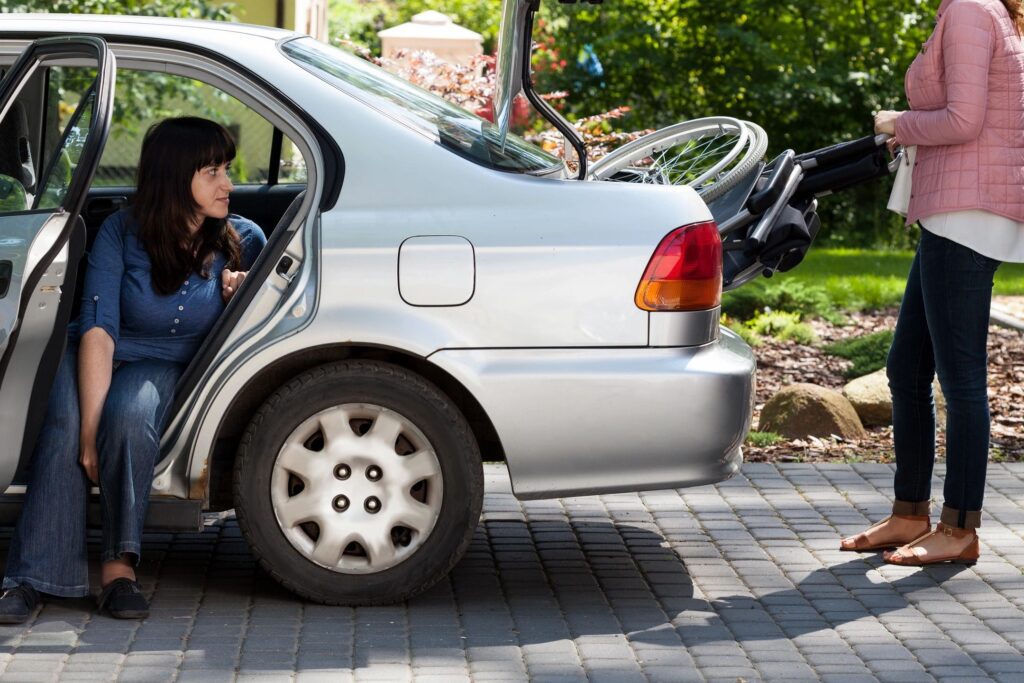 A woman sitting in the drivers seat of her car.